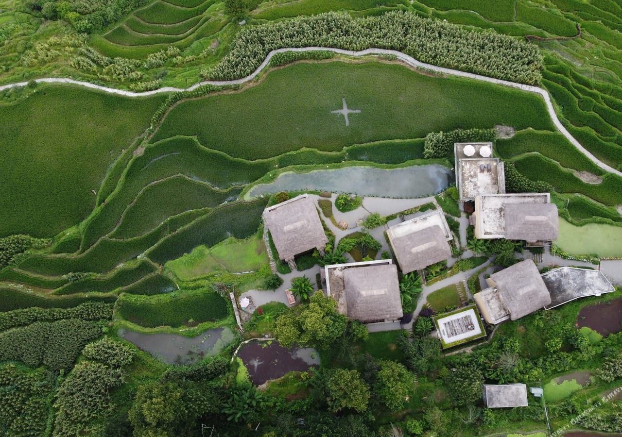 Azheke village from above, thatched Hani houses set among green rice terraces