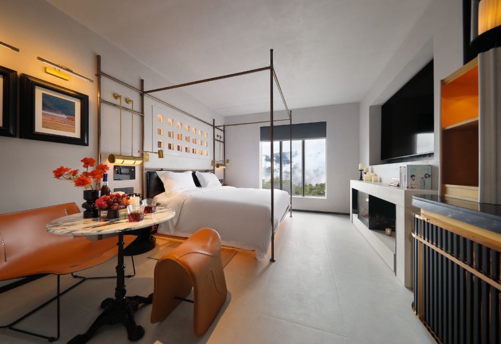 Z Hotel Supreme · Feilai Si — a guest room with slim brass four-poster canopy bed, fireplace and a picture window onto the cloud-wrapped valley