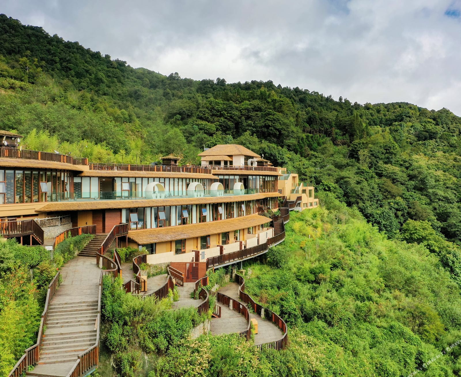 Duoyishu Half-Mountain — curved, stepped wings set into the hillside