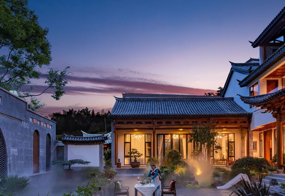 He Ting · Awamei — courtyard pavilion lit at dusk, Lijiang