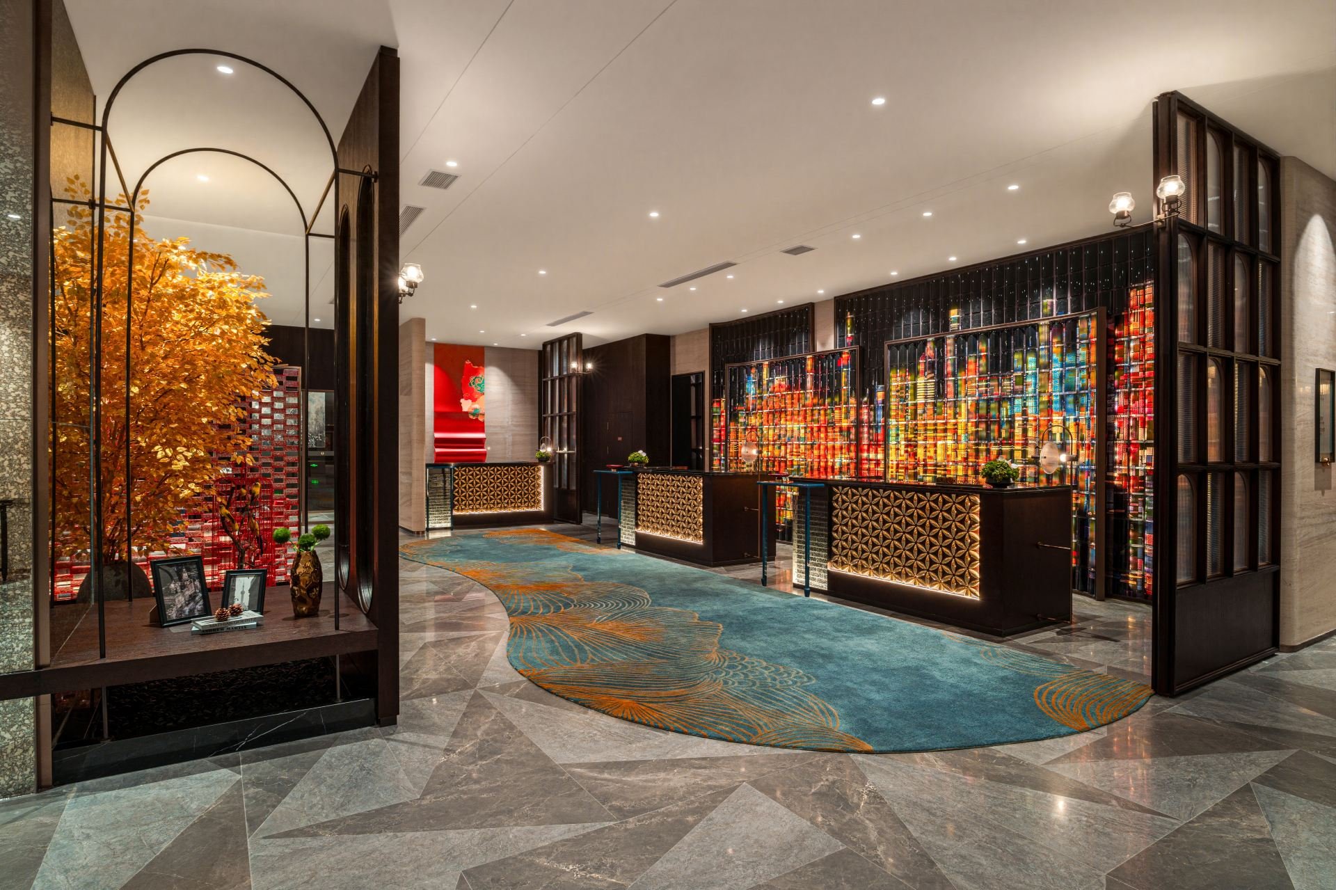Jianguo Palace Hotel — the lobby, a gold-leaf tree against a wall of Shanghai skyline art