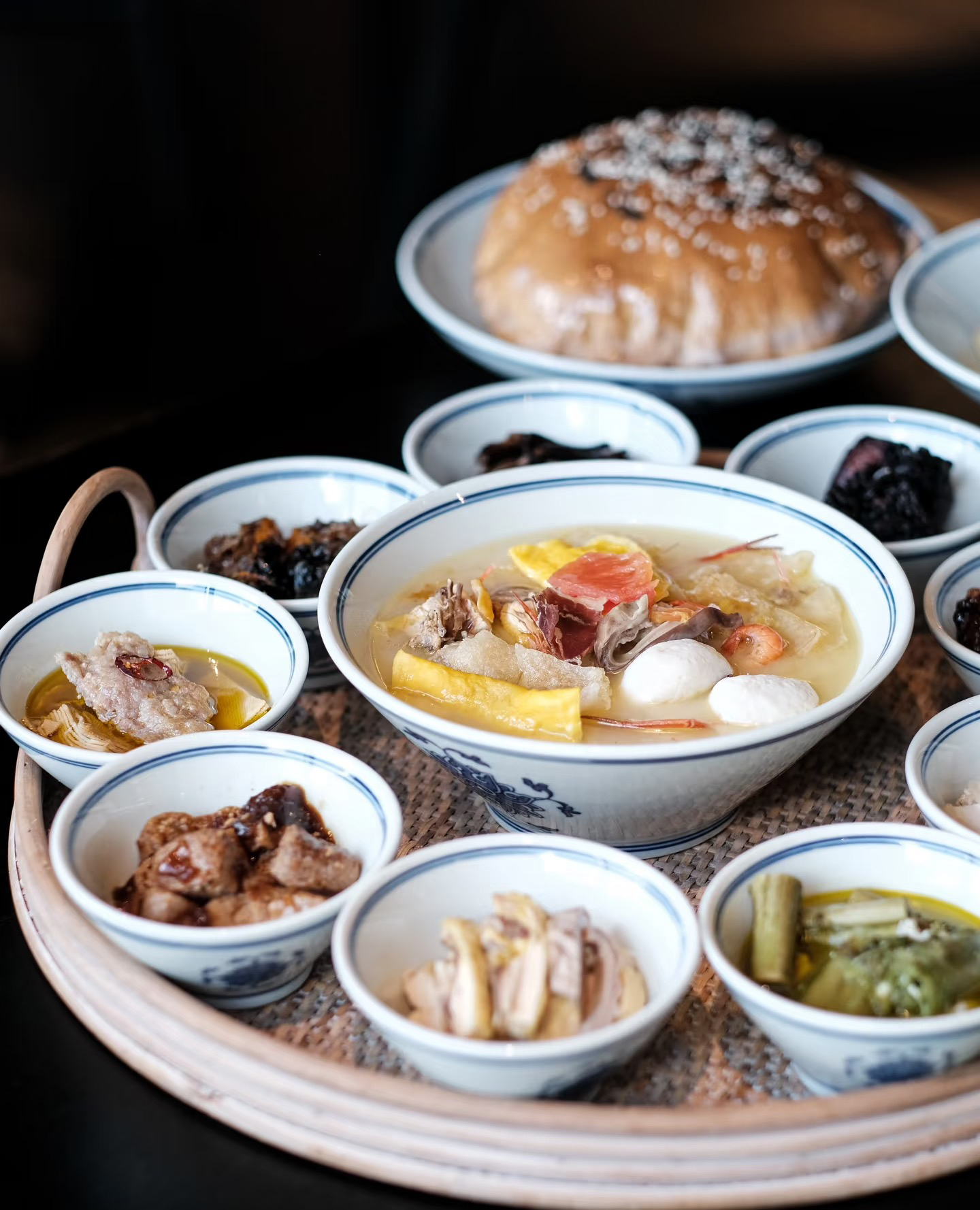 A tray of small dishes around a bowl of soup